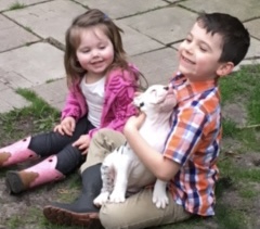 Children holding puppy